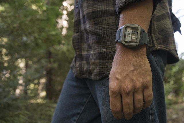 Man in the forest wearing a Nixon Regulus Expedition watch