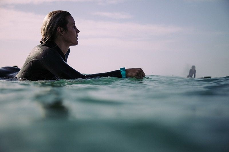 A surfer floats in the water